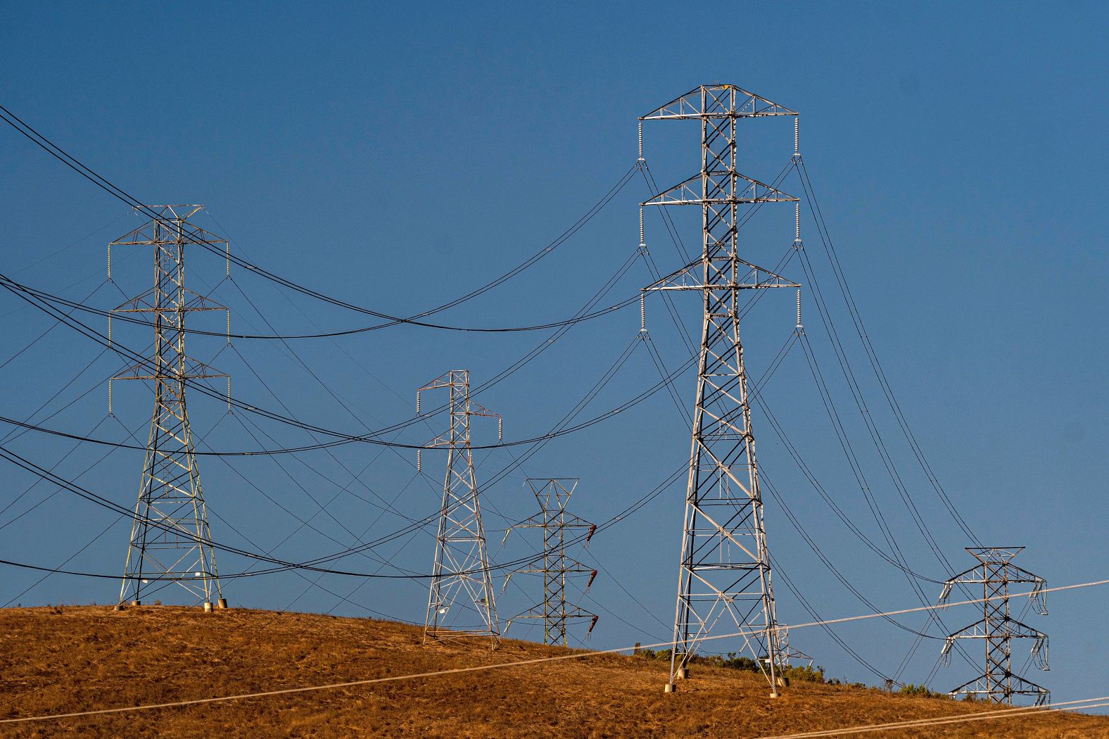 Electrical transmission towers are seen in Vallejo, California, on Sunday, September 4. Blisteringly hot temperatures and a rash of wildfires are posing a twin threat to California's power grid.
