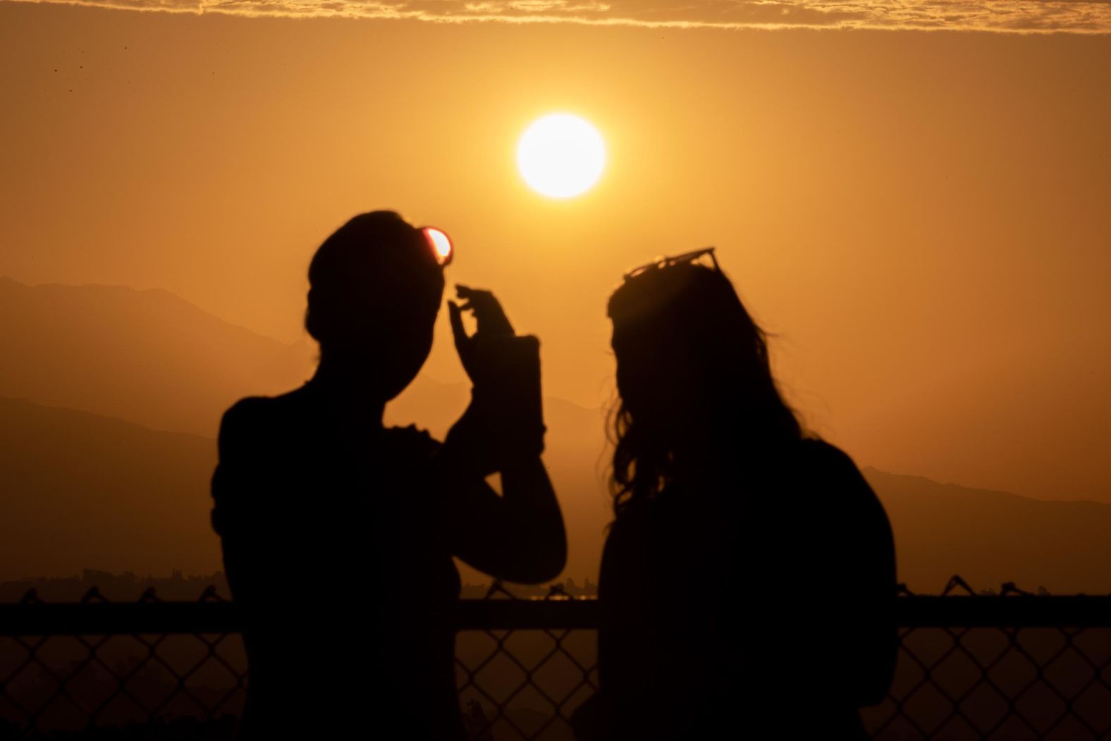 The sun rises over mountains as seen from the Griffith Observatory in Los Angeles on Saturday, September 3.