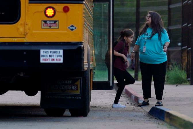 A student gets off a bus at Uvalde Elementary.