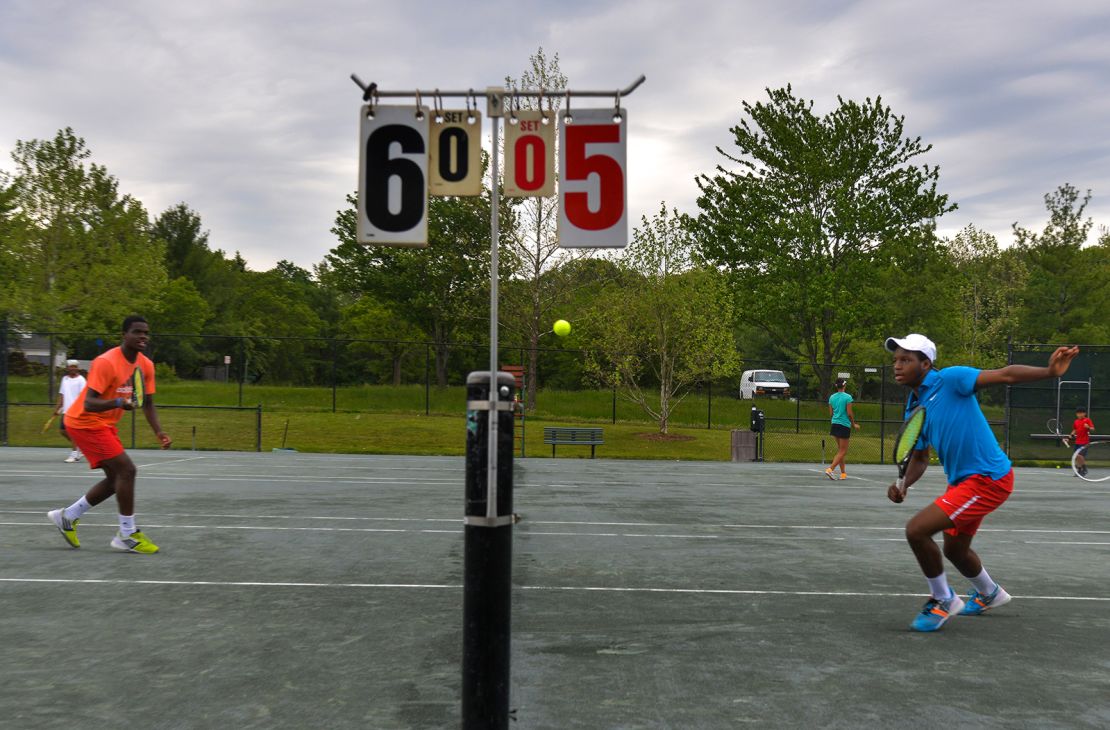 Tiafoe and his twin brother Franklin play in a fundraiser tournament in 2014.