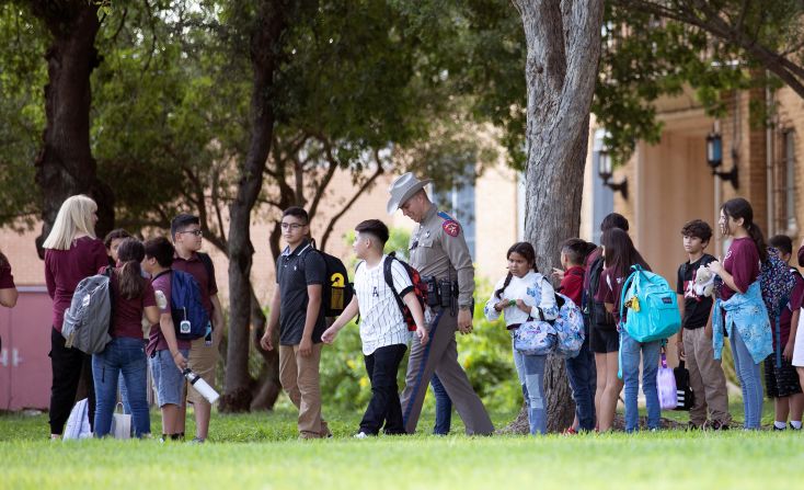 Students at Flores Elementary School in Uvalde wait to be picked up after their first day back at school. 