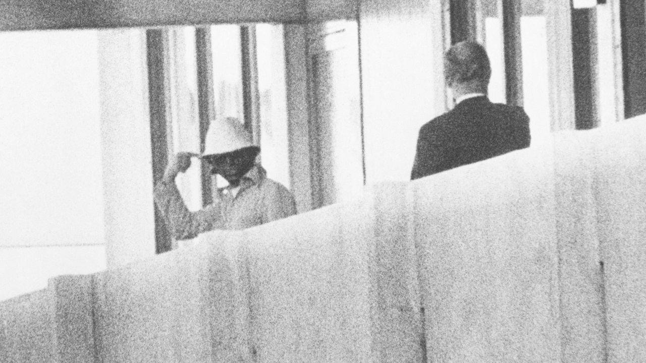 An Olympic committee member (R) speaks to one of the Palestinian militants at the Munich Olympic Village in 1972.