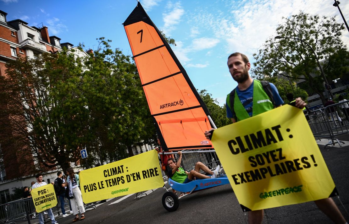 Greenpeace activists protest outside of the Parc des Princes.