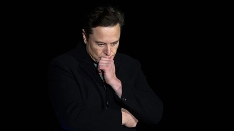 Elon Musk pauses and looks down as he speaks during a press conference at SpaceX's Starbase facility near Boca Chica Village in South Texas on February 10, 2022. 