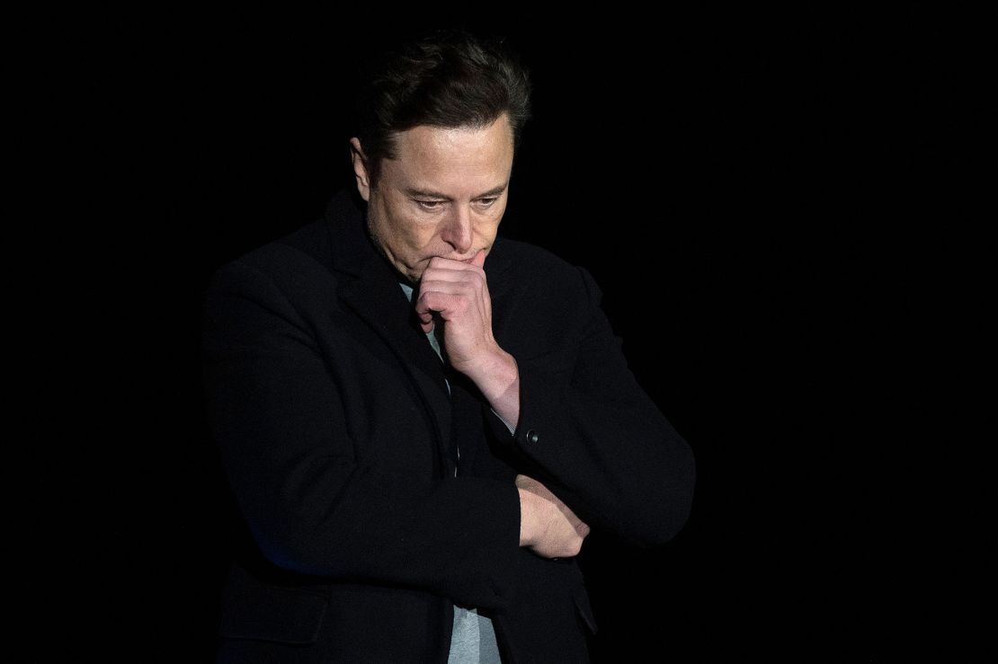 Elon Musk pauses and looks down as he speaks during a press conference at SpaceX's Starbase facility near Boca Chica Village in South Texas on February 10, 2022. 
