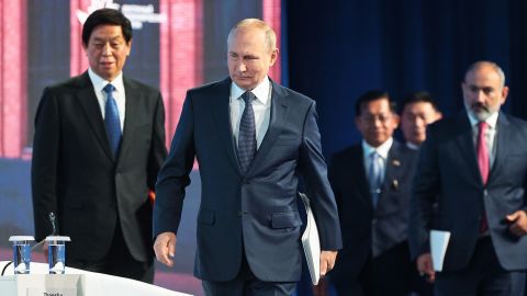 Russian President Vladimir Putin, center, Chairman of China's National People's Congress Standing Committee Li Zhanshu, left, and Armenian Prime Minister Nikol Pashinyan, right, arrive to attend a plenary session at the Eastern Economic Forum in Vladivostok, Russia on September 7.