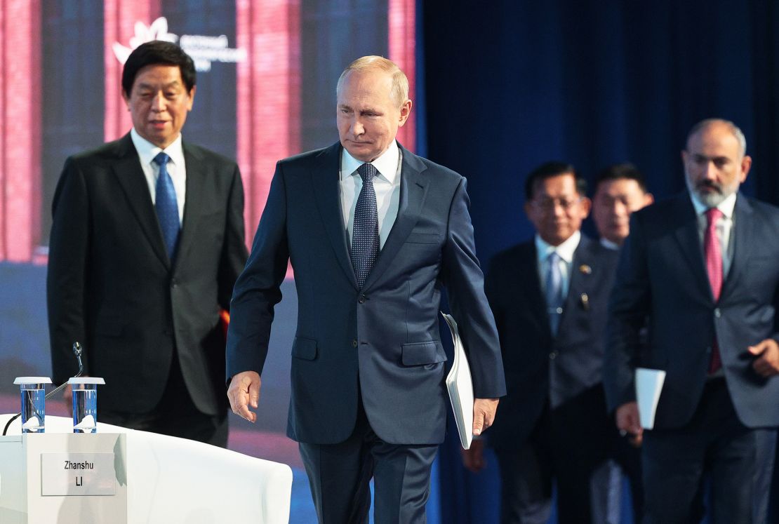 Russian President Vladimir Putin, center, Chairman of China's National People's Congress Standing Committee Li Zhanshu, left, and Armenian Prime Minister Nikol Pashinyan, right, arrive to attend a plenary session at the Eastern Economic Forum in Vladivostok, Russia on September 7.
