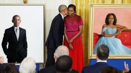 Former U.S. President Barack Obama kisses former first lady Michelle Obama during the unveiling of their official White House portraits, painted by Robert McCurdy and Sharon Sprung, respectively, in the East Room of the White House, in Washington, U.S., September, 7, 2022. REUTERS/Evelyn Hockstein