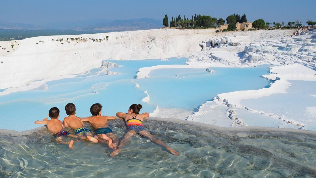 <strong>Strong bond:</strong> Lemay and Pelletier say one of the highlights has been witnessing the bond between their four children, seen here swimming in the thermal pools of Pamukkale, Turkey. 