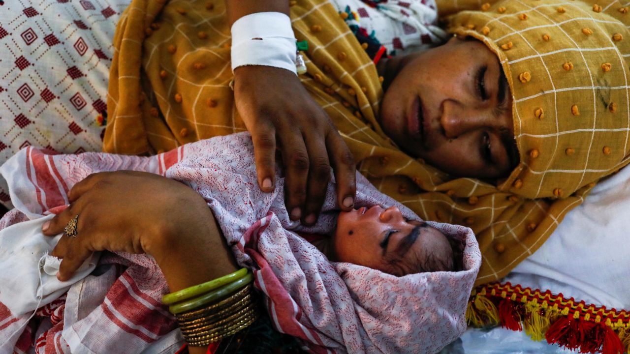 A mother in Sehwan, Pakistan, looks after her newborn son. 