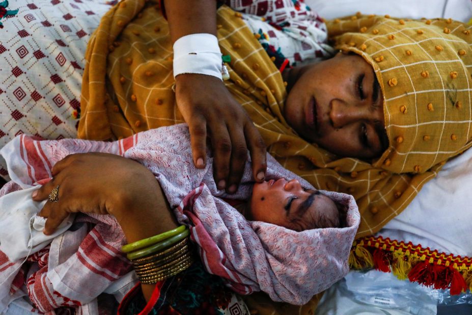 An 18-year-old woman displaced by the flooding looks after her 1-day-old baby boy at a hospital in Sehwan, Pakistan, on Wednesday, September 7.