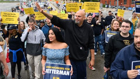 John Fetterman, lieutenant governor of Pennsylvania and Democratic Senate candidate, center, and his wife Gisele Fetterman, center left, walk with the United Steelworkers District 10 during a Labor Day parade in Pittsburgh on Monday.