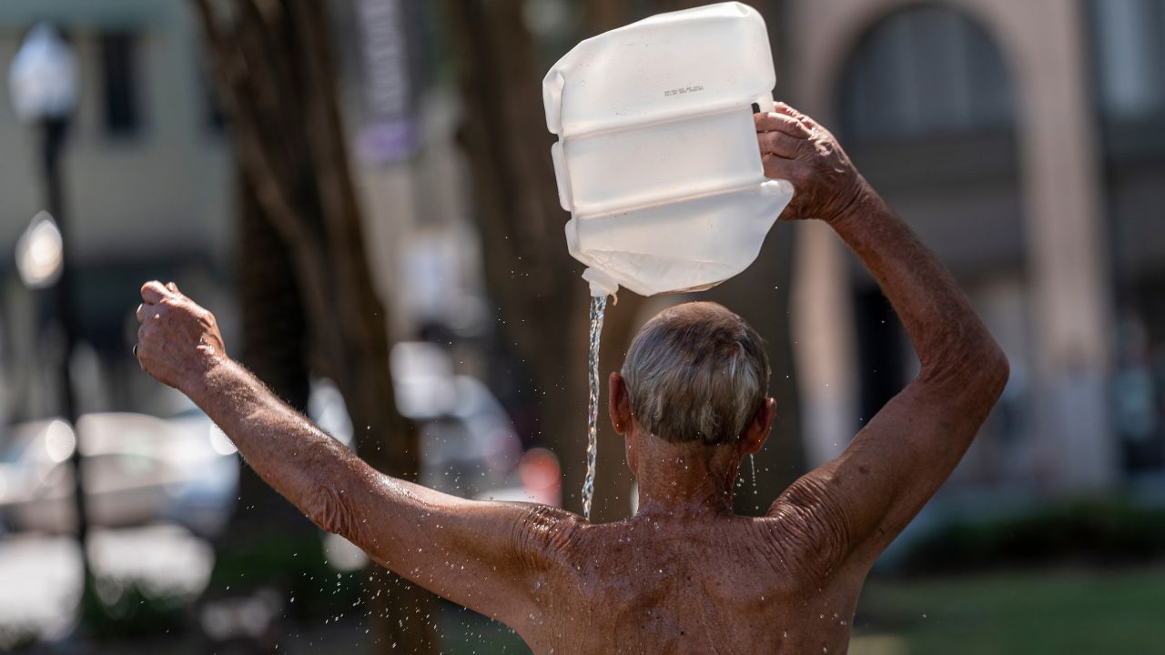 A resident cools off Tuesday with a bottle of water during a heat wave in Sacramento, California.