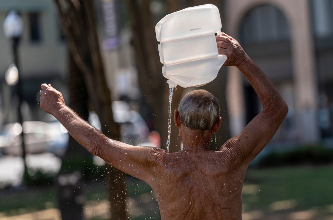 A resident cools off Tuesday with a bottle of water during a heat wave in Sacramento, California.