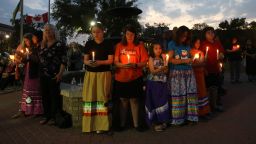 People hold candles during a vigil for the stabbing attack victims in Prince Albert, Saskatchewan, Canada, on September 7, 2022. - The last suspect in the stabbing spree in a remote western Canadian Indigenous community died after being arrested on September 7, 2022 at the end of a long manhunt, local media said. (Photo by LARS HAGBERG / AFP) (Photo by LARS HAGBERG/AFP via Getty Images)