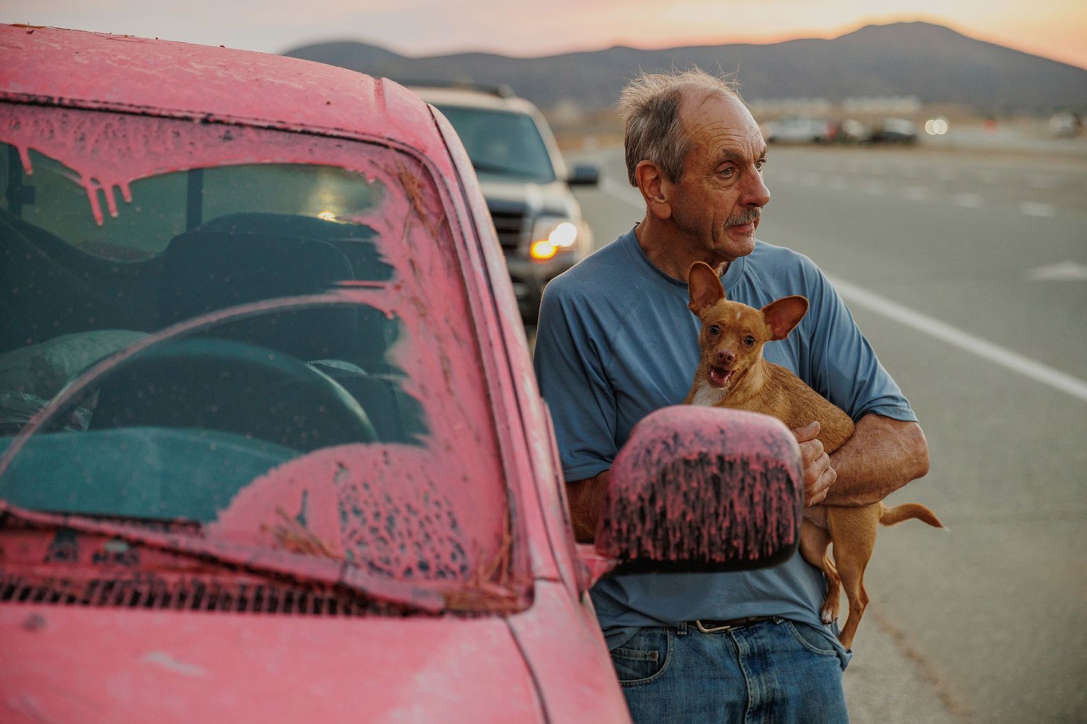 Rick Fitzpatrick holds a dog after evacuating from the Fairview Fire near Hemet on September 5. The wildfire forced residents to flee amid a severe heat wave that has enveloped the region.