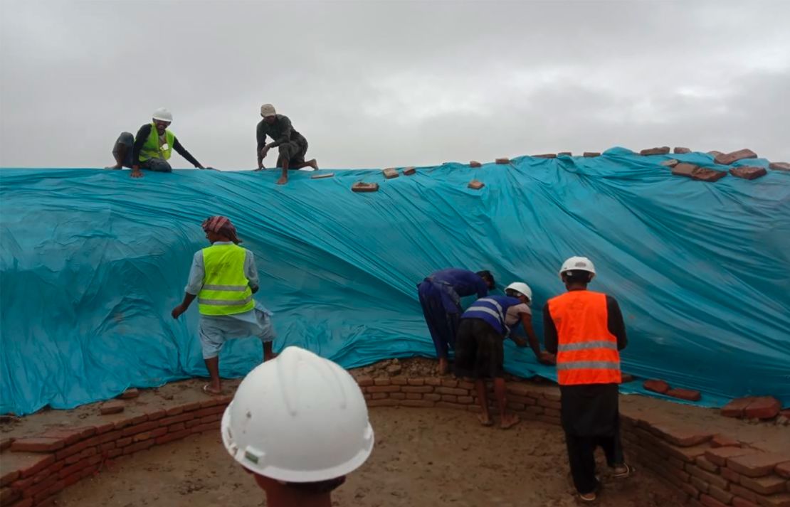 Workers rushed to cover as much of the site as possible with protective covers.