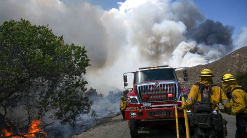 Smoke rises into pyrocumulus clouds as firefighters try to contain wildfires along Bautista Canyon Road during the Fairview Fire in the San Bernardino National Forest near Hemet, California, on September 7, 2022. 