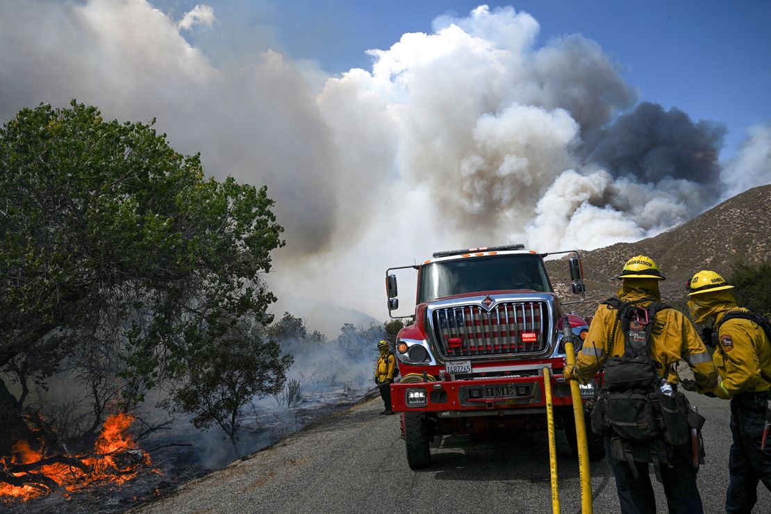 Smoke rises into a pyrocumulus cloud as firefighters work to contain wildfire along Bautista Canyon Road during the Fairview Fire in the San Bernardino National Forest near Hemet, California, on September 7, 2022. 