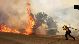A firefighter works at a back burn during the Fairview Fire on September 7, 2022 near Hemet, California. 