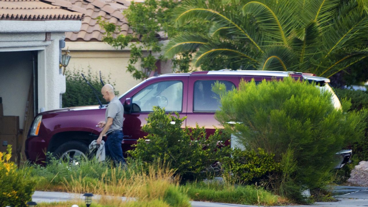 Outgoing Clark County Public Administrator Robert Telles washes his car outside his home on Tuesday, Sept. 6, 2022, in Las Vegas. Authorities served search warrants at Telles home on Wednesday, Sept. 7, 2022, in connection with the fatal stabbing  of Las Vegas Review-Journal investigative reporter Jeff German. (Benjamin Hager/Las Vegas Review-Journal via AP)