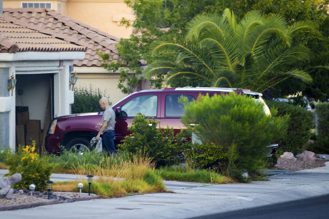 Clark County Public Administrator Robert Telles washes his car Tuesday outside his home in Las Vegas. Authorities served search warrants at Telles home Wednesday in connection with the fatal stabbing of Las Vegas Review-Journal investigative reporter Jeff German. 