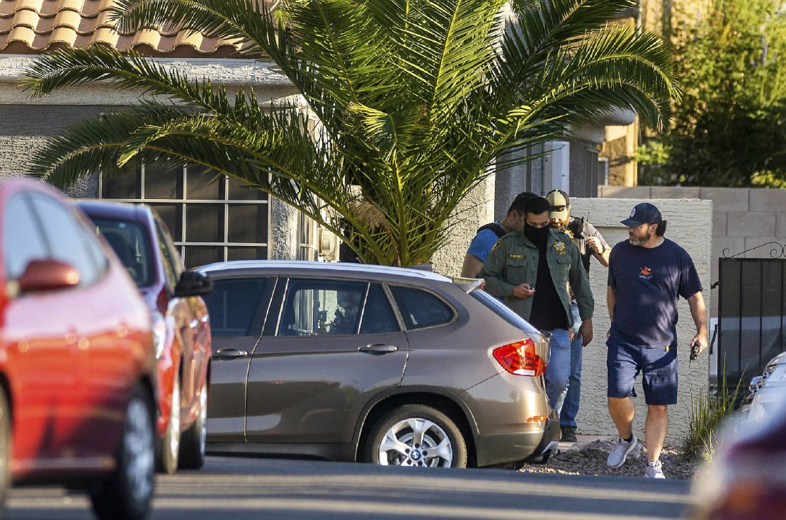 Officers in Las Vegas leave Robert Telles' home Wednesday.