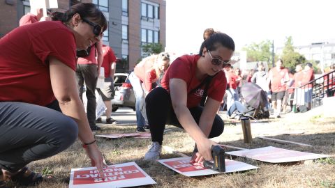 Teachers Jayde Sorbello, left, and Sarah Evans from the Kent, Washington, School District help assemble picket signs as teachers at Seattle Public Schools picket outside Roosevelt High School in Seattle on what was supposed to be the first day of classes Wednesday.