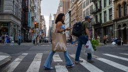Pedestrians walk through a shopping district in Manhattan on August 26, 2022 in New York City. 