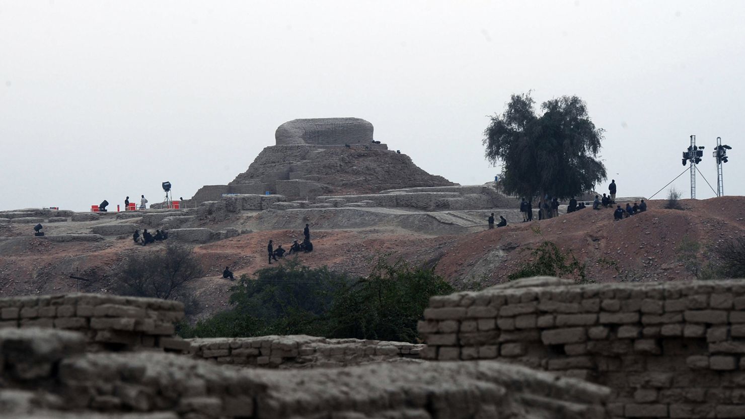 Pakistani policemen sit around the ancient ruins of Moenjodaro, the UNESCO World Heritage site around 425 kilometres north of t