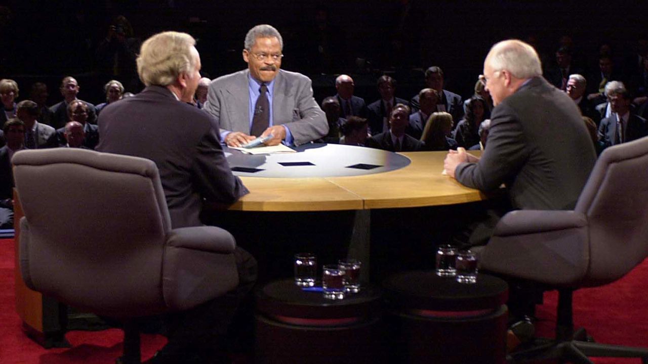 Democratic vice presidential candidate Joseph Lieberman (L), Republican presidential candidate Richard Cheney (R) join moderator Bernard Shaw of CNN on stage for their debate at Centre College's Norton Center for the Arts in Danville, Kentucky 05 October, 2000. This is the only vice presidential debate scheduled before the 07 November election.    
