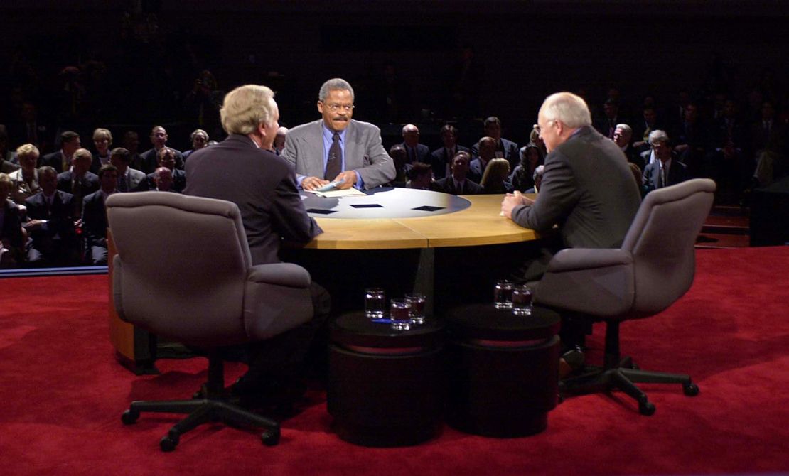 Democratic vice presidential candidate Joseph Lieberman (L), Republican presidential candidate Richard Cheney (R) join moderator Bernard Shaw of CNN on stage for their debate at Centre College's Norton Center for the Arts in Danville, Kentucky 05 October, 2000. This is the only vice presidential debate scheduled before the 07 November election.    