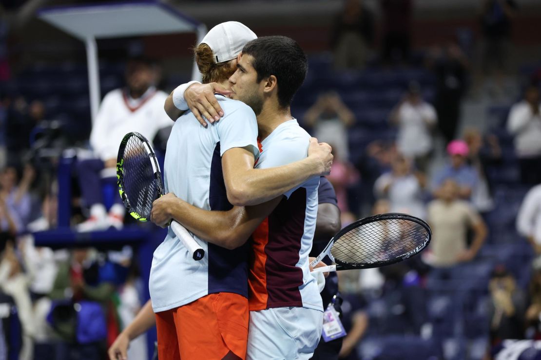 Alcaraz and Sinner embrace after their marathon quarterfinal at the US Open. 