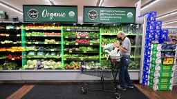 A shopper looks at organic produce at a supermarket in Montebello, California, on August 23, 2022. - US shoppers are facing increasingly high prices on everyday goods and services as inflation continues to surge with high prices for groceries, gasoline, and housing.