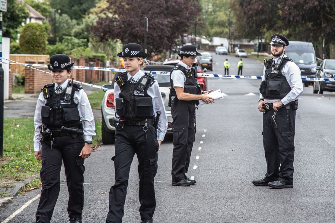 Police officers stand on guard at the crime scene in Kirkstall Gardens.