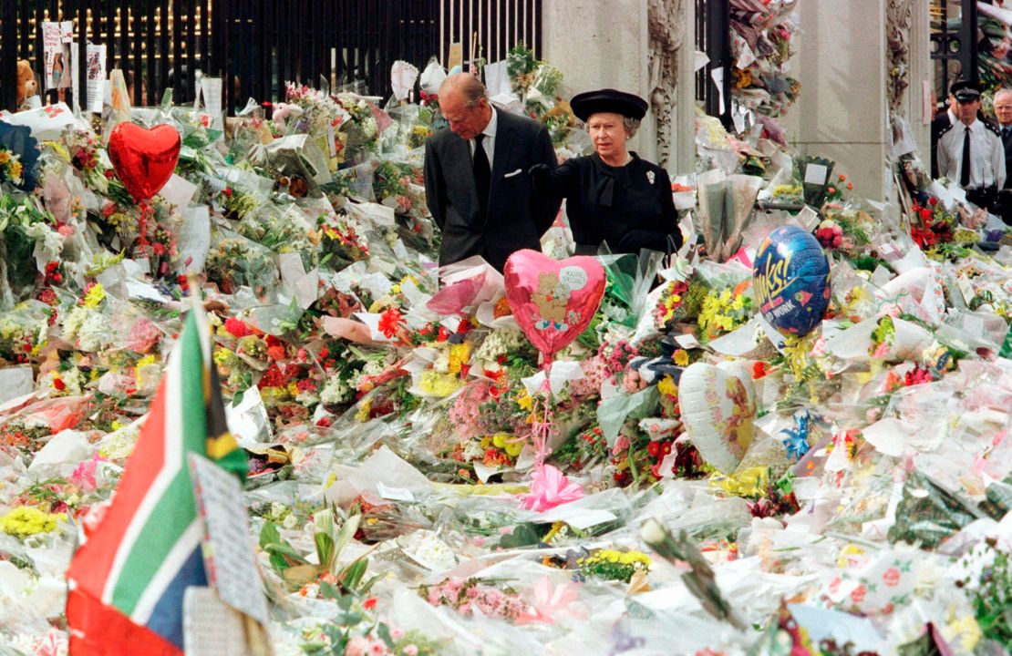 Britain's Queen Elizabeth II and Prince Philip view the floral tributes to Diana, Princess of Wales, at London's Buckingham Palace, on September 5, 1997.  
