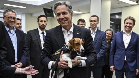 US Secretary of State Antony Blinken holds Patron, a landmine sniffer dog, during his visit to a children's hospital in Kyiv.