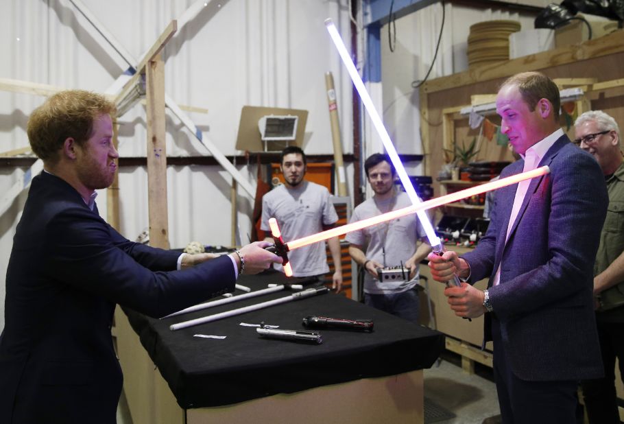 Prince William and Prince Harry try out "Star Wars" lightsabers during a tour of the movie sets in Iver Heath, England, in April 2016.