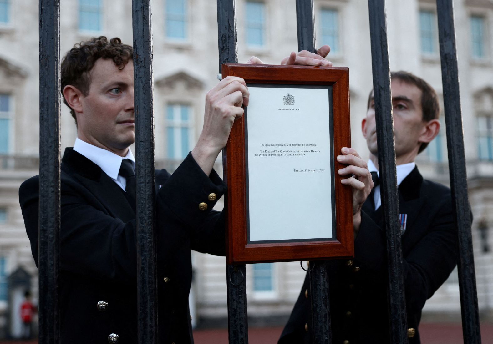 A notice is placed on a fence outside Buckingham Palace, announcing the Queen's death on September 8. "The Queen died peacefully at Balmoral this afternoon," the statement read. "The King and The Queen Consort will remain at Balmoral this evening and will return to London tomorrow."