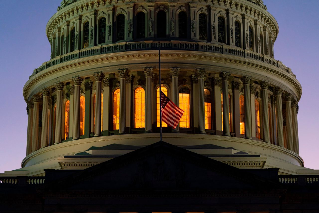 The American flag flies at half-staff over the US Capitol in Washington, DC.