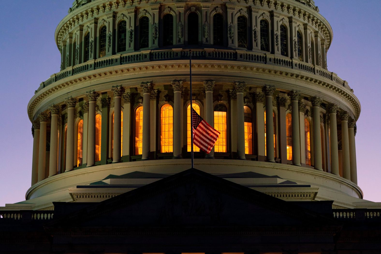 The American flag flies at half-staff over the US Capitol in Washington, DC.