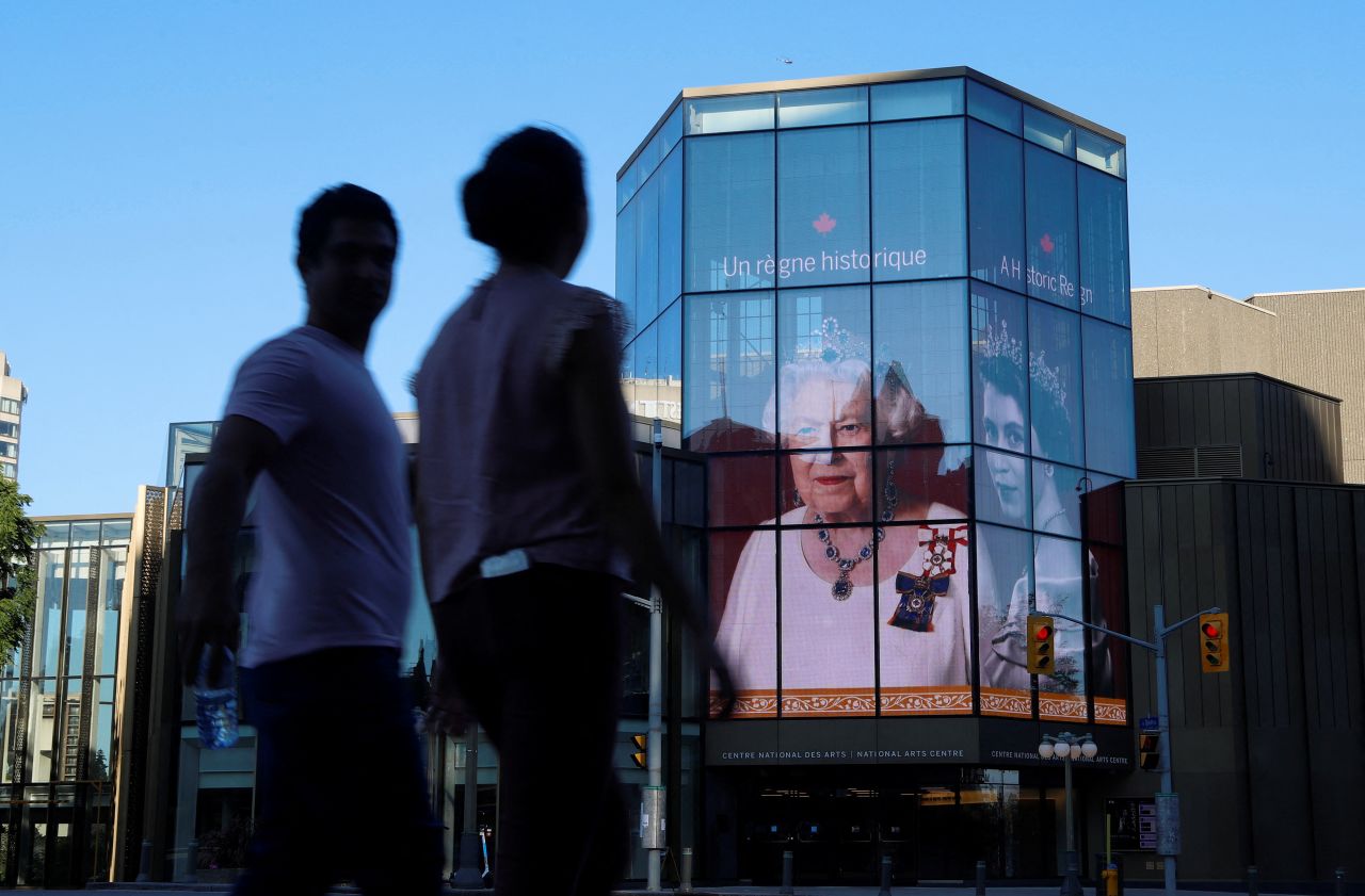 People walk by a Queen tribute at the National Arts Center in Canada's capital of Ottawa.
