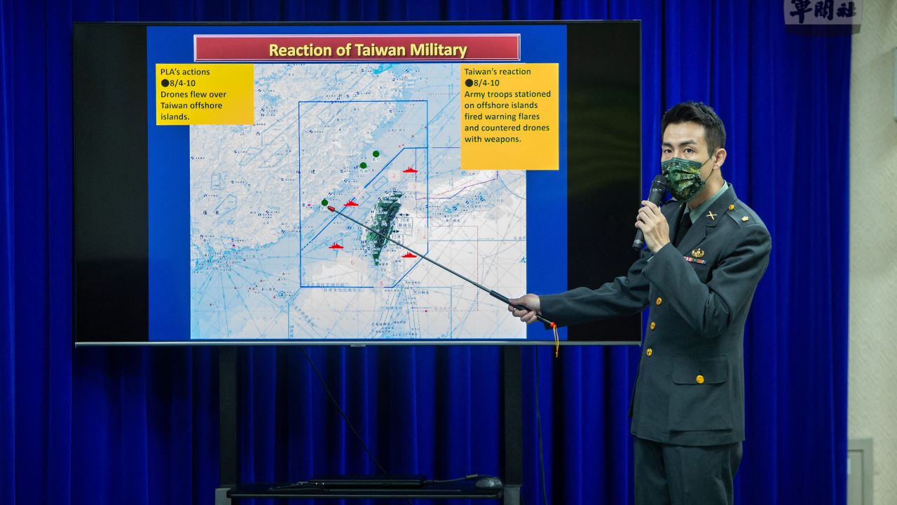 A Taiwanese major points at a map showing recent drone incursions.
