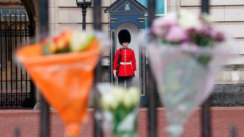 Flowers are left on the gate at Buckingham Palace.
