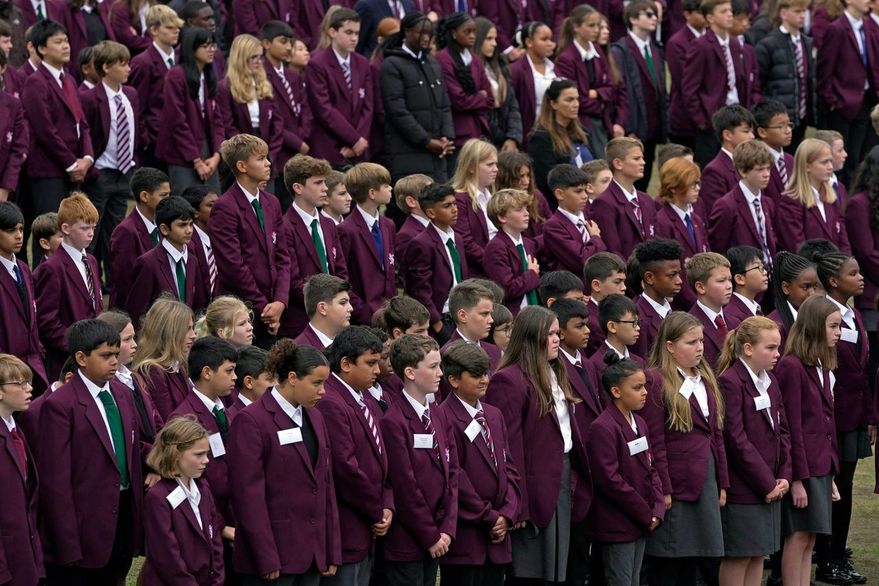 Students gather to pay their respects for the Queen at the Royal Russell School in London.