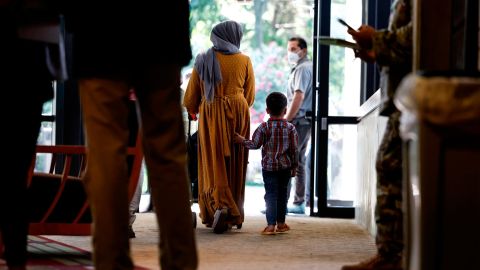 An Afghan national and her son walk through the National Conference Center (NCC), which in recent months has been redesigned to temporarily house Afghan nationals on August 11, 2022 in Leesburg, Virginia. 