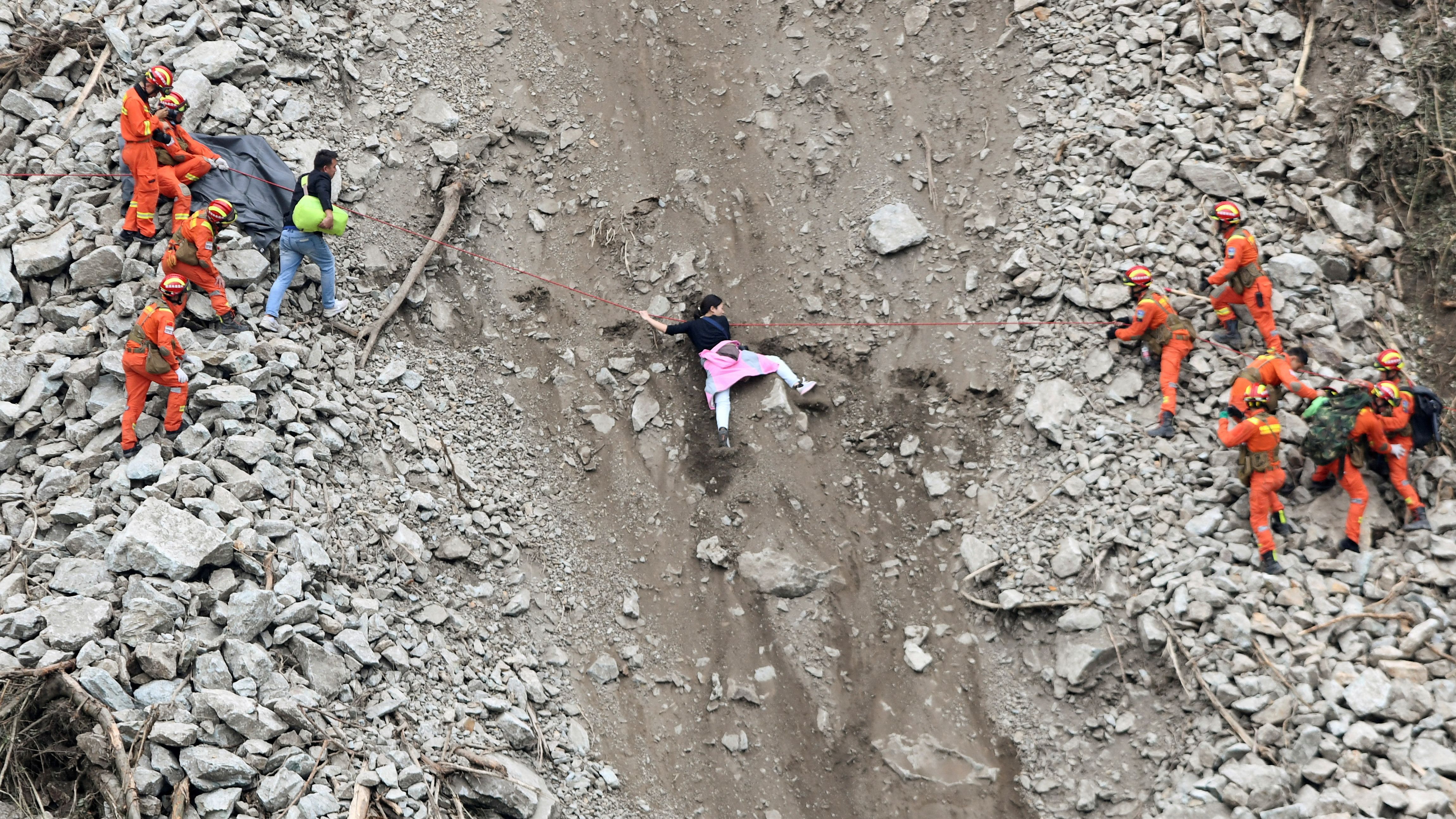 Rescue workers help people after <a href="https://www.cnn.com/2022/09/05/china/china-earthquake-sichuan-intl-hnk/index.html" target="_blank">an earthquake</a> caused a landslide near Moxi Town, China, on Tuesday, September 6.