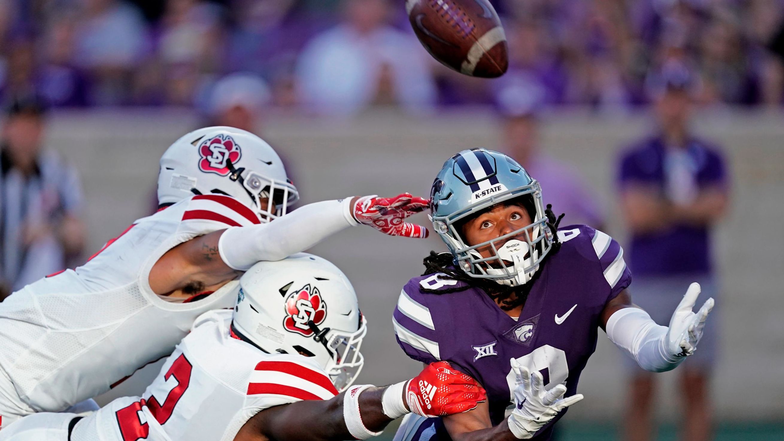 South Dakota players break up a pass intended for Kansas State wide receiver Phillip Brooks during a college football game in Manhattan, Kansas, on Saturday, September 3.