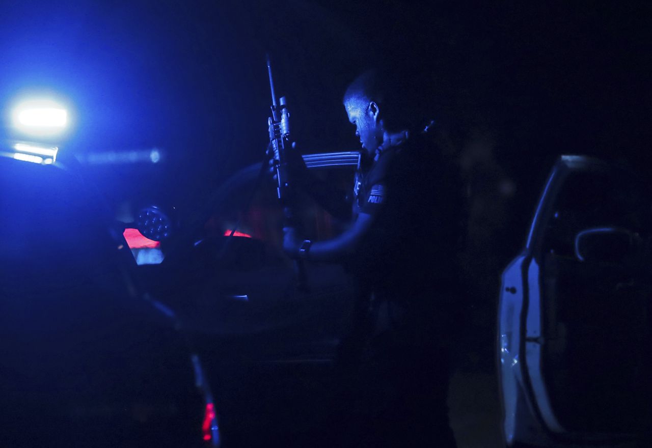 A police officer loads his gun at a crime scene in Memphis, Tennessee, on Wednesday, September 7. A 19-year-old man was arrested Wednesday after livestreaming part of a <a href="https://www.cnn.com/2022/09/07/us/memphis-shootings-suspect-detained/index.html" target="_blank">shooting rampage</a> that left four people dead and three others injured, police said.