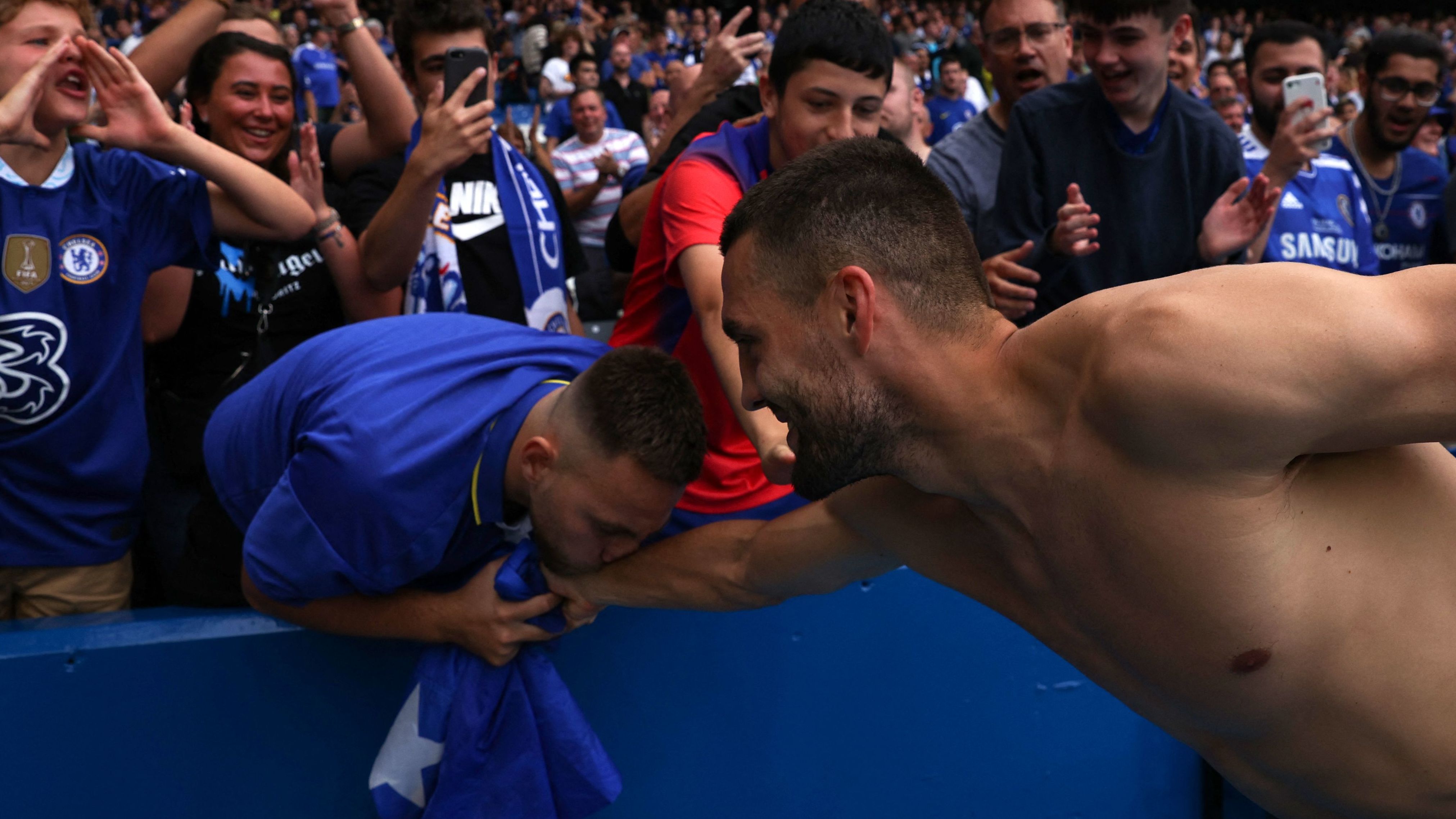 A fan kisses Chelsea's Mateo Kovacic after the player gave him his jersey following a Premier League match in London on Saturday, September 3.